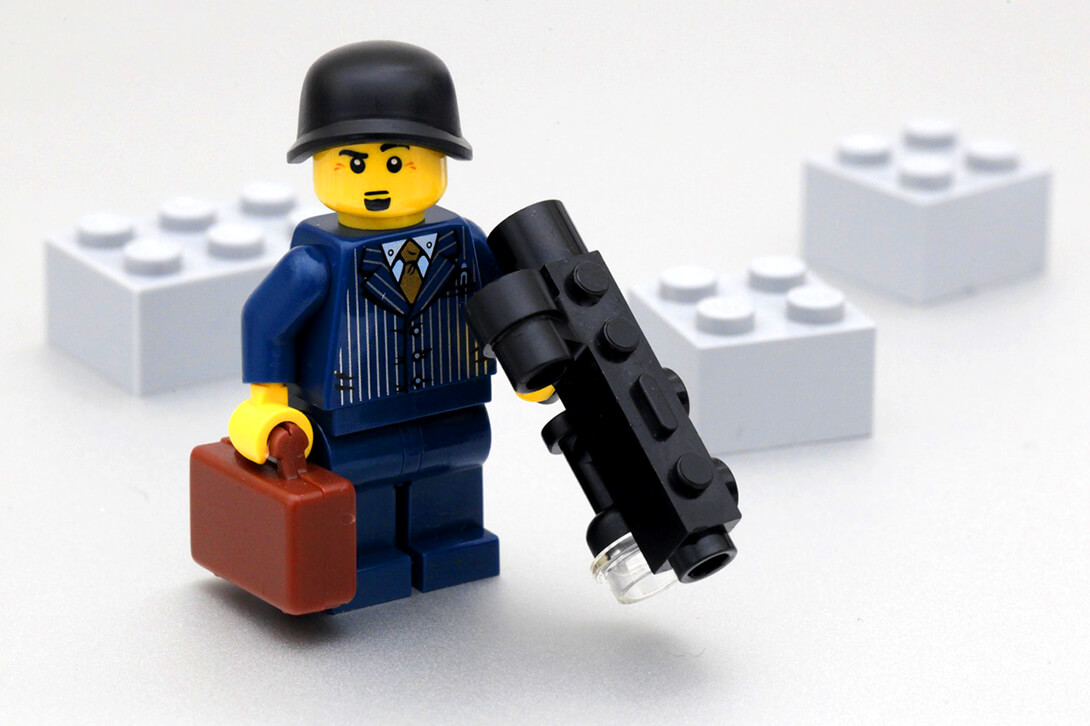 Image of lego business man holding a black gun. Phoenix company directors are essentially criminals in nice suits.